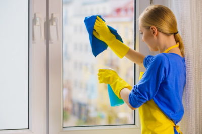 窓を掃除している女性