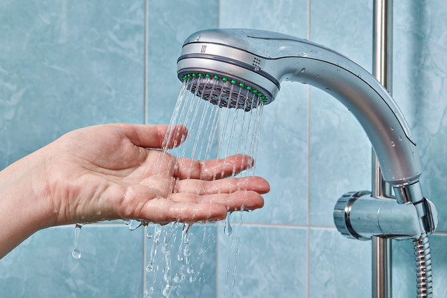 シャワーから出ている水を受け止めている女性の手