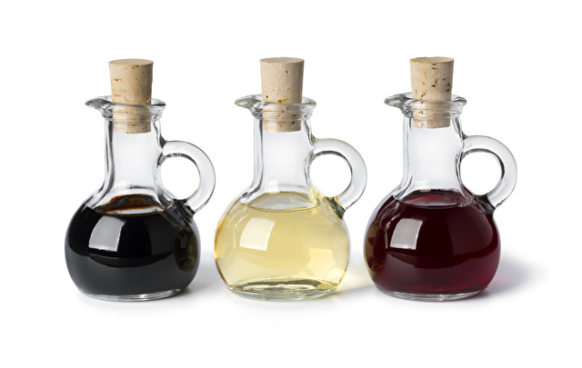 Glass bottles with different types of vinegar