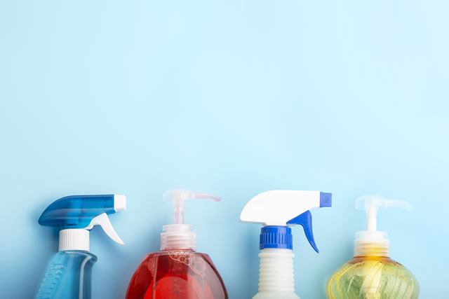 Cleaning products on blue background with copy space, spring cleaning concert