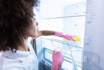 Woman Wearing Gloves Cleaning Refrigerator