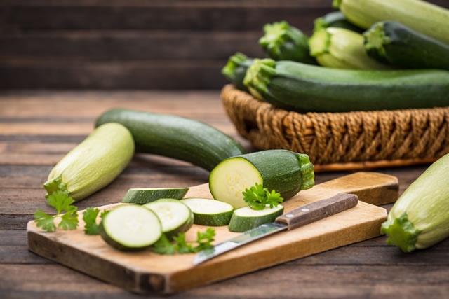 Fresh organic zucchini on the wooden table