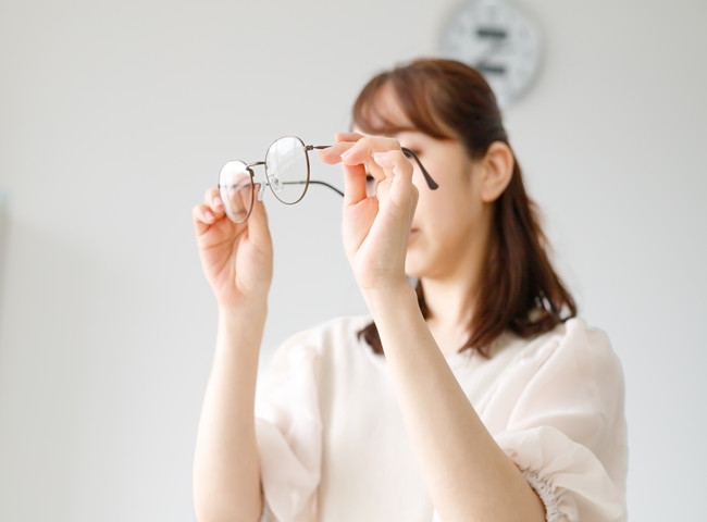 眼鏡のレンズやフレームの品質をチェックしている女性