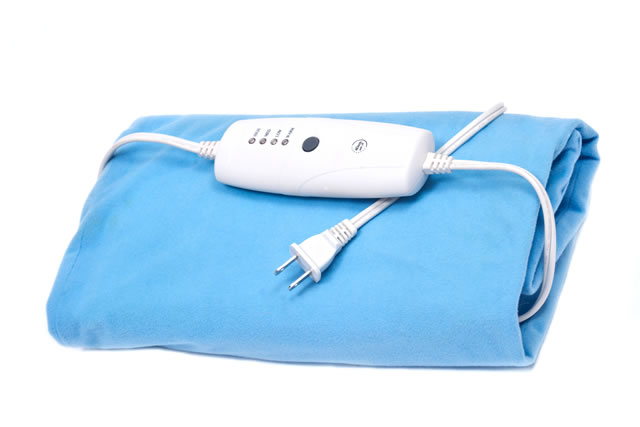 Blue electric heating pad isolated on white background