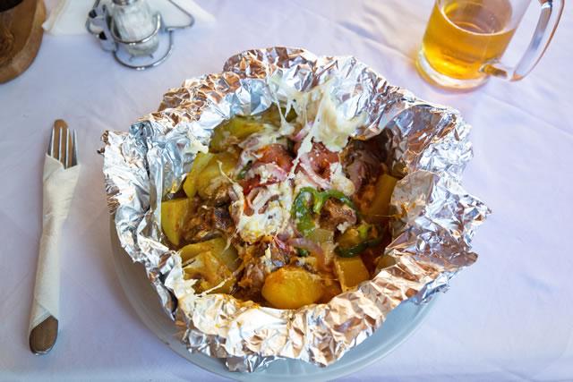 Kleftiko - slowly cooked lamb with vegetables and feta cheese. Traditional Greek dish.