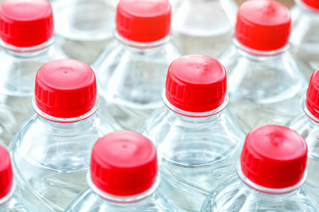 plastic water bottles with red caps